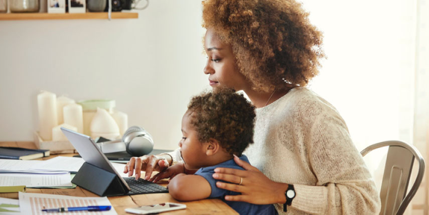 woman with child looking at computer