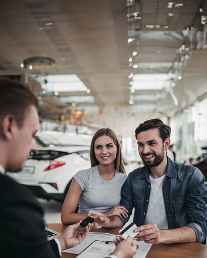 couple smiling purchasing car